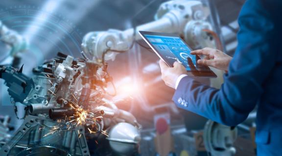 man in suit at machines with tablet